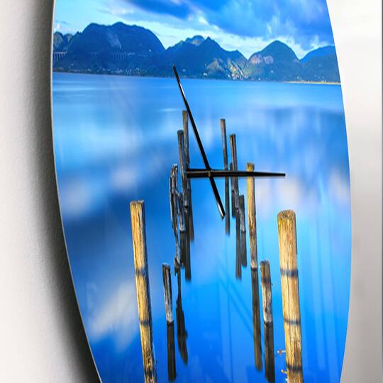 Designart 'Wooden Pier Remains In Blue Sea Modern Wall Clock
